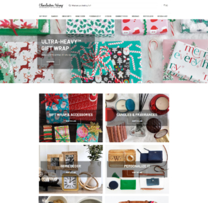 Website design for a holiday shop featuring a festive background image, showcasing seasonal decorations and vibrant colors.