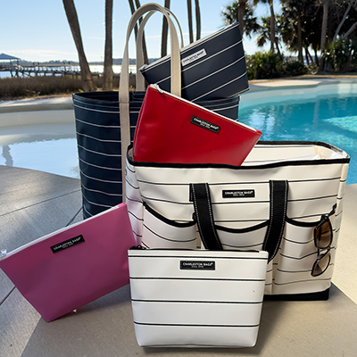 Assorted bags are positioned next to a pool, each displaying unique patterns and colors.